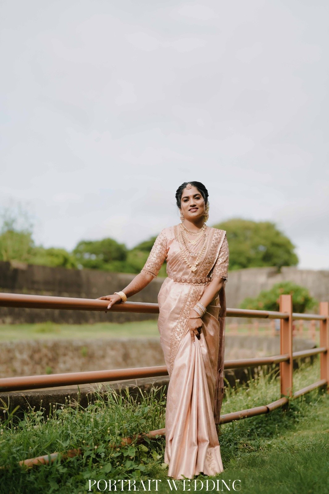 Full-length Bride in Peach Silk Saree